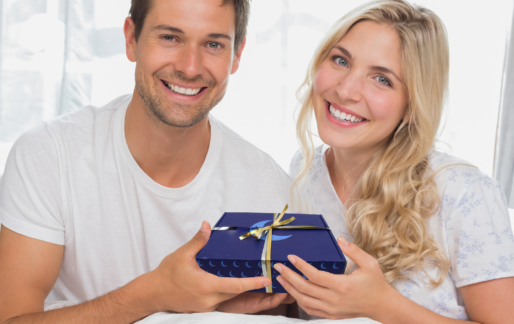 Cute young couple gifting a ZQuiet anti-snoring mouthguard