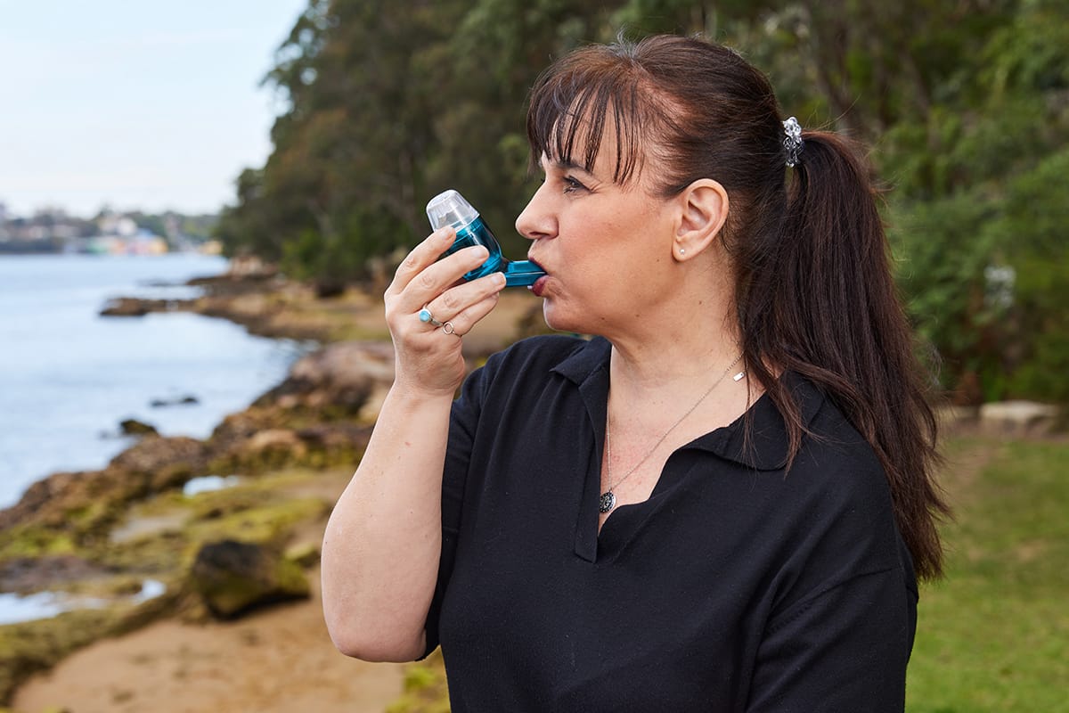 A women outside using AirPhysio to breath better